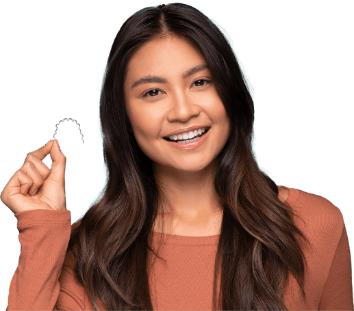 Girl holds InSmile Lingual Braces